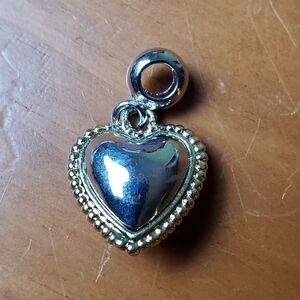 NWOT charm, silver colored heart with gold colored trim